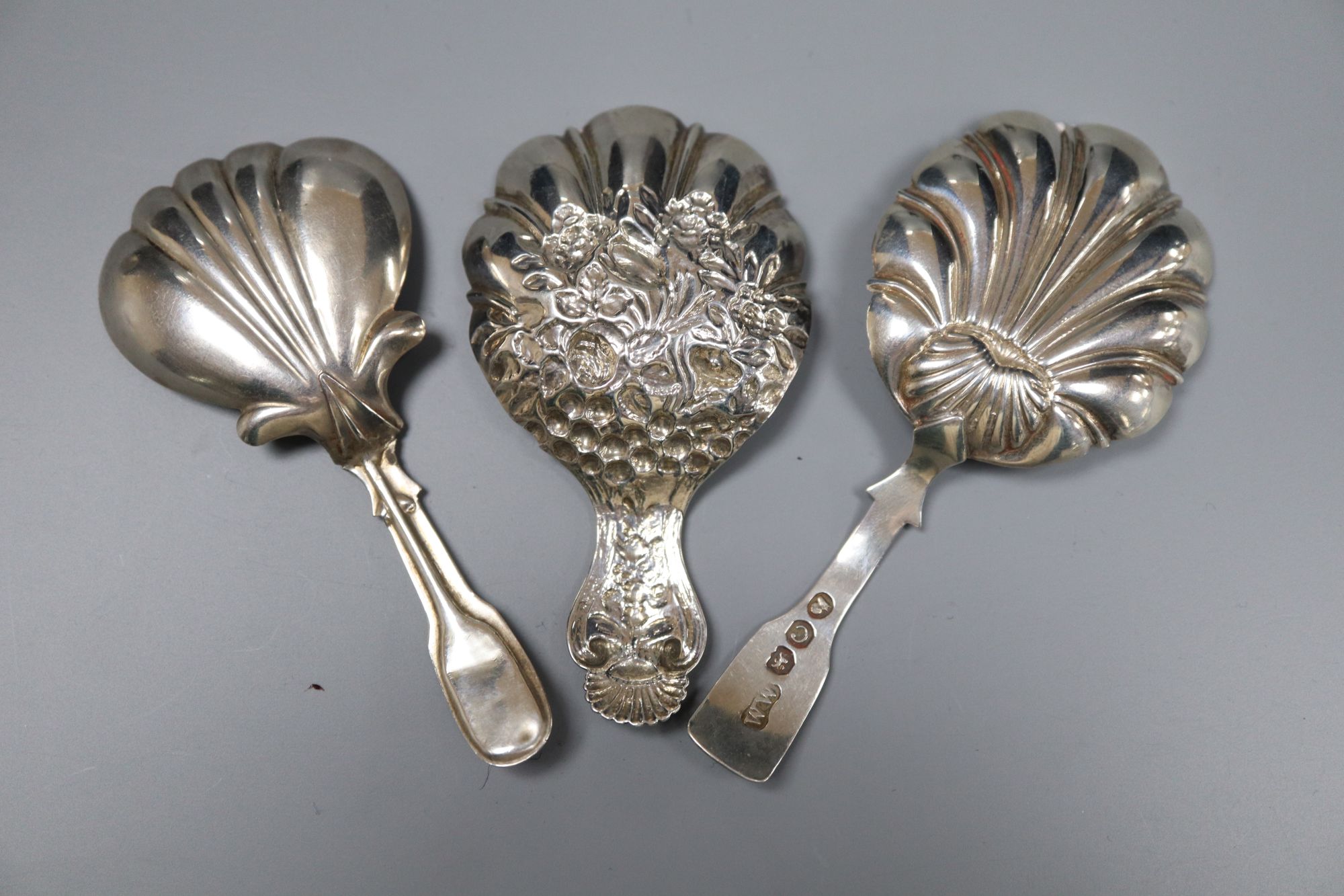 Three 19th century silver caddy spoons including embossed by Joseph Wilmore, Birmingham, 1825, 75mm.